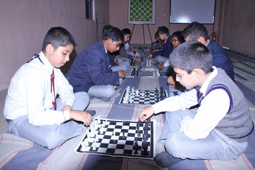 Students learning and practicing various chess strategies